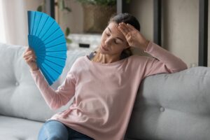 Woman-trying-to-find-relief-from-broken-AC