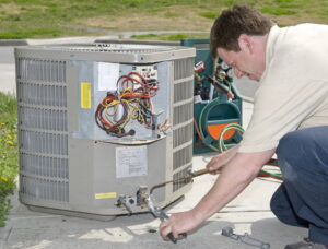technician-inspecting-and-working-on-ac-cabinet-outdoors